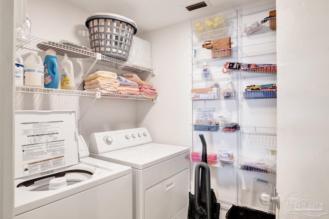 clothes washing area featuring washer and dryer