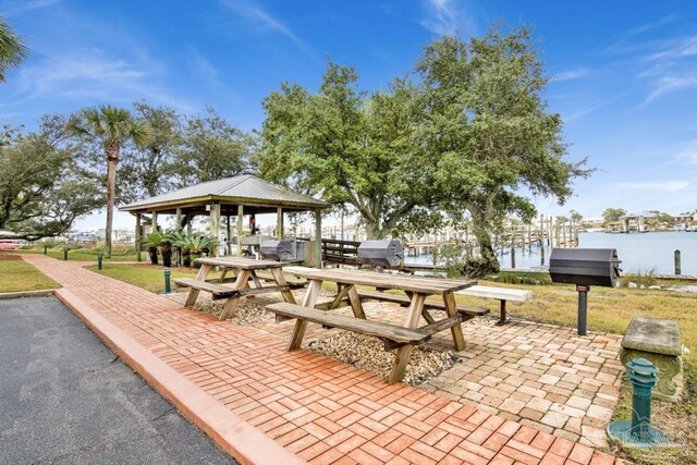 surrounding community with a gazebo and a water view