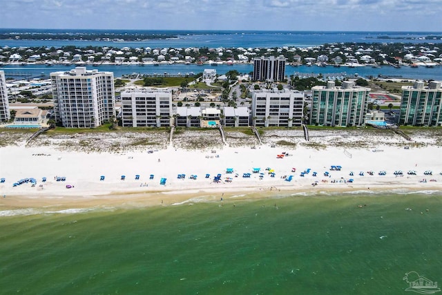 bird's eye view with a water view and a beach view