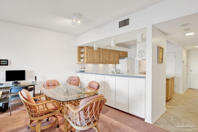 dining area with light tile patterned floors