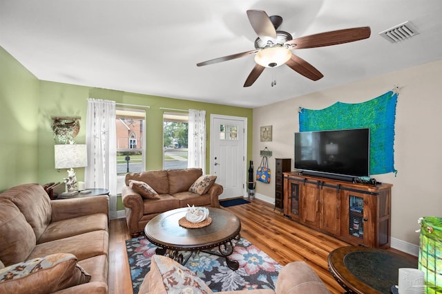 living room with ceiling fan and hardwood / wood-style floors