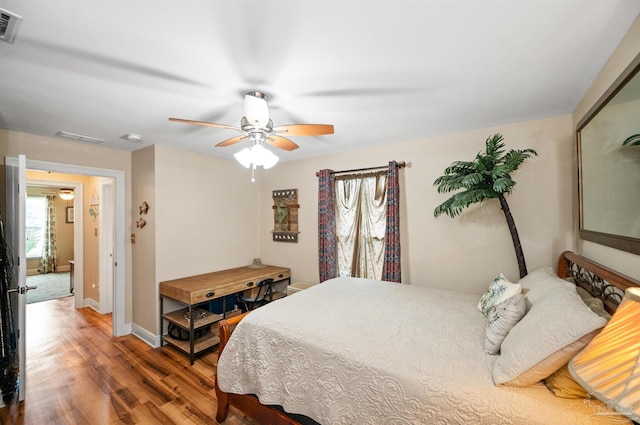 bedroom with ceiling fan and hardwood / wood-style flooring