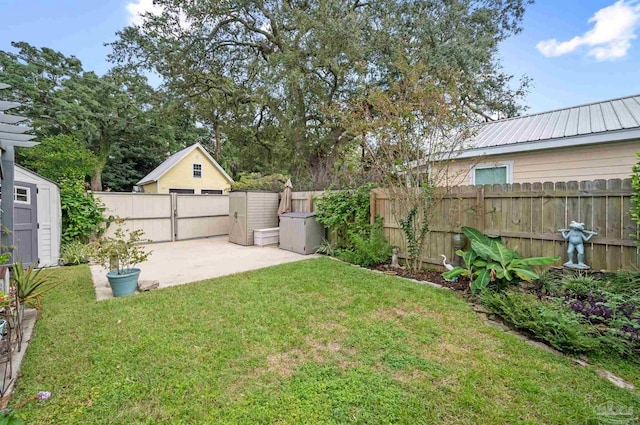 view of yard with a patio and a storage unit