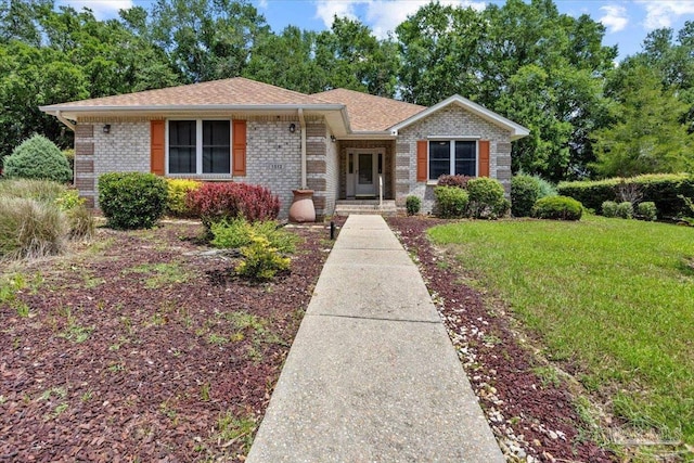 1512 Hunters Creek Cir, Cantonment, FL 32533 - view of front of house featuring brick siding, a front lawn, and roof with shingles