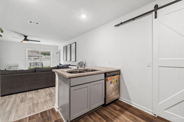 4348 Jitterbug St, Milton, FL 32583 - kitchen with dishwasher, a sink, gray cabinetry, dark wood-type flooring, and a barn door