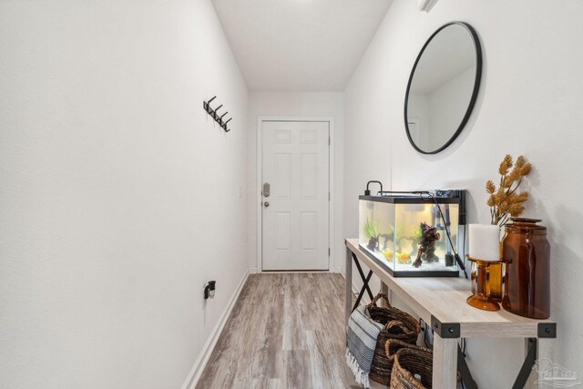 4348 Jitterbug St, Milton, FL 32583 - doorway to outside featuring light wood-style flooring and baseboards