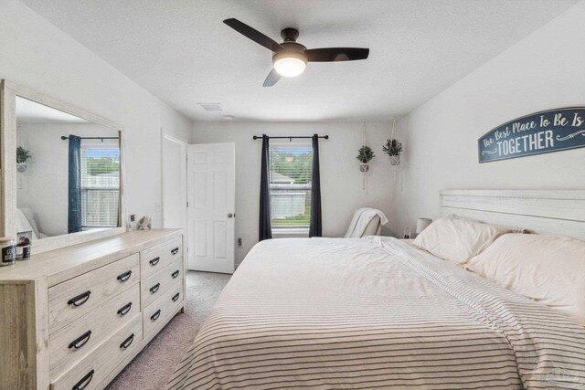 4348 Jitterbug St, Milton, FL 32583 - bedroom with light colored carpet, a ceiling fan, and a textured ceiling