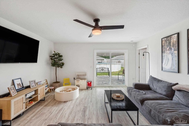 4348 Jitterbug St, Milton, FL 32583 - living area featuring wood finished floors, a ceiling fan, and a textured ceiling