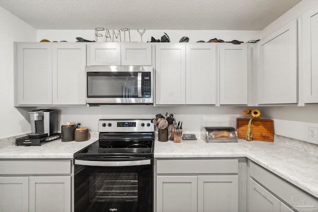 4348 Jitterbug St, Milton, FL 32583 - kitchen with appliances with stainless steel finishes, light countertops, and a textured ceiling