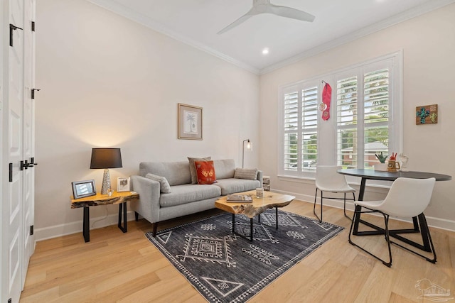 living room with ornamental molding, light hardwood / wood-style floors, and ceiling fan