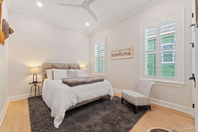 bedroom featuring light wood-type flooring, ceiling fan, and crown molding