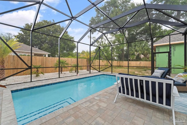 view of swimming pool with a lanai and a patio