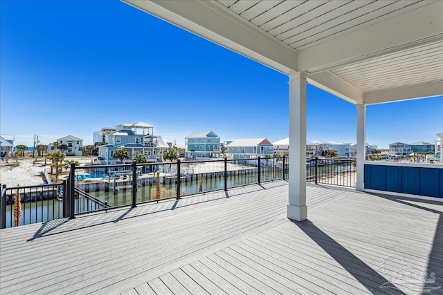 deck with a water view and a residential view