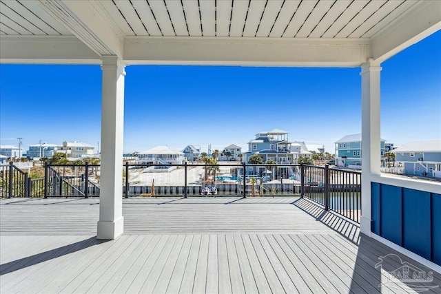 wooden deck with a water view and a residential view