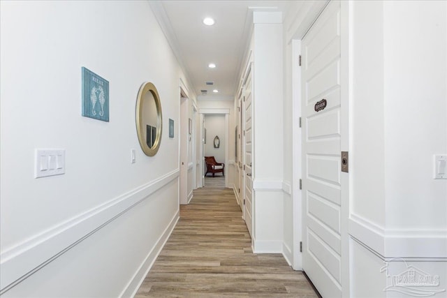 hall with recessed lighting, baseboards, crown molding, and light wood finished floors