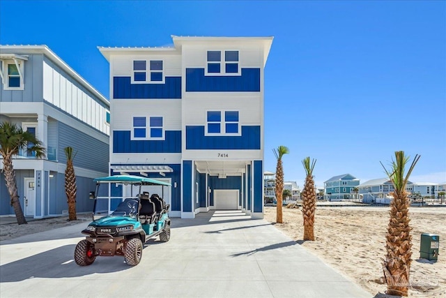 view of front of house featuring board and batten siding and concrete driveway