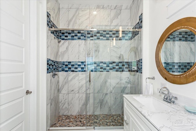 bathroom with a stall shower and vanity