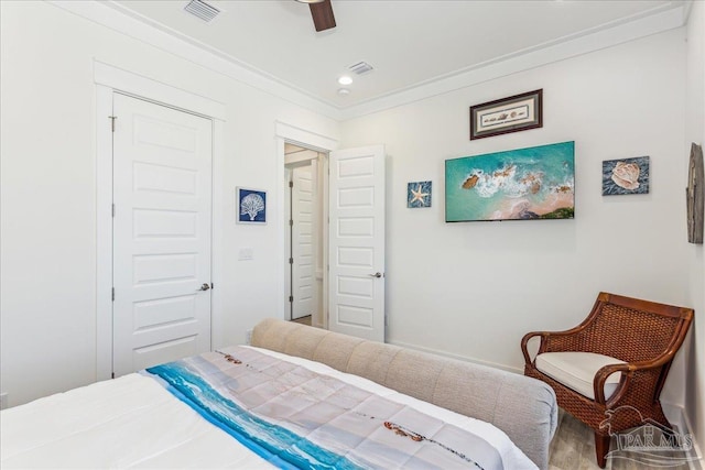 bedroom featuring ornamental molding, a closet, visible vents, and a ceiling fan