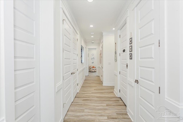 corridor with light wood-style floors and recessed lighting