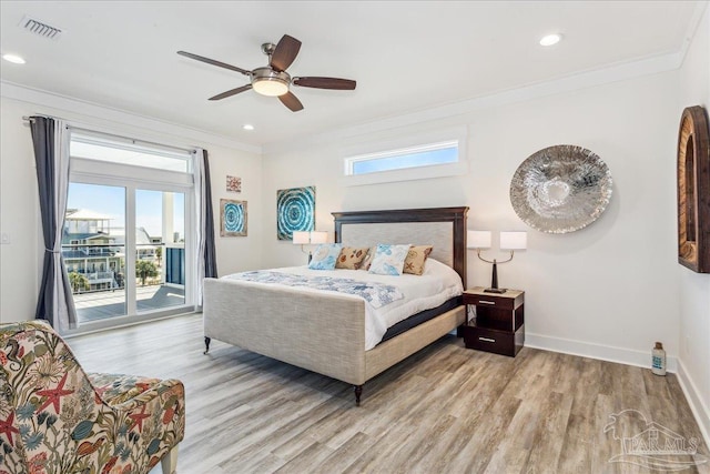 bedroom with ornamental molding, access to outside, visible vents, and wood finished floors