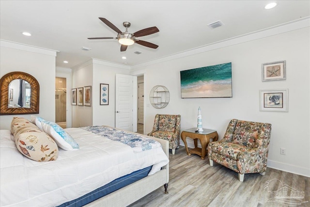 bedroom with crown molding, visible vents, wood finished floors, and recessed lighting