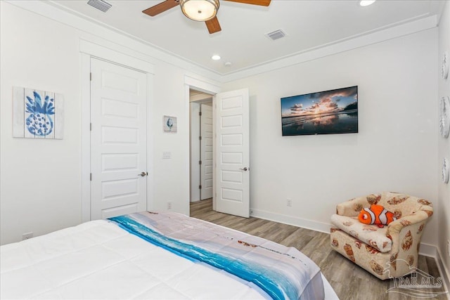 bedroom with recessed lighting, visible vents, and wood finished floors