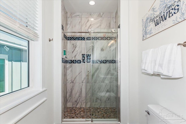 full bath featuring toilet, a shower stall, a wealth of natural light, and recessed lighting