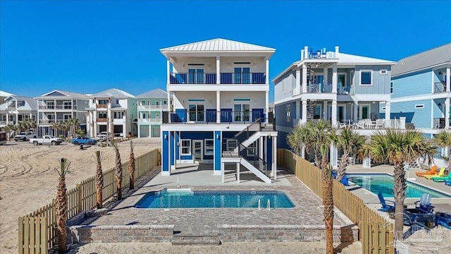 rear view of property featuring a fenced in pool, fence private yard, a patio area, and a residential view