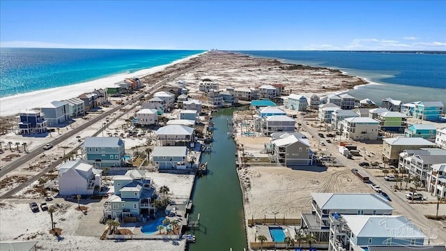 birds eye view of property featuring a beach view and a water view