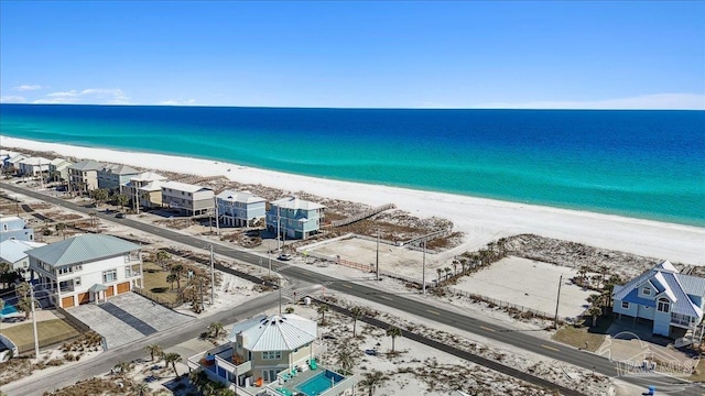 aerial view with a water view and a beach view