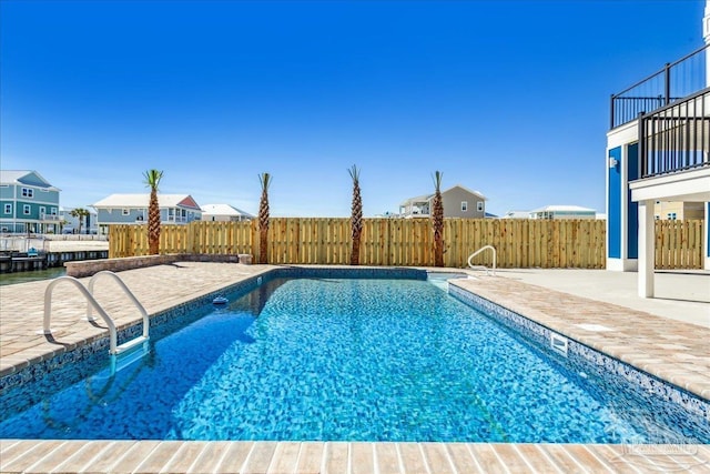 view of swimming pool featuring a fenced in pool, a patio area, and fence