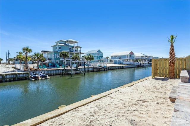 dock area with a water view and fence