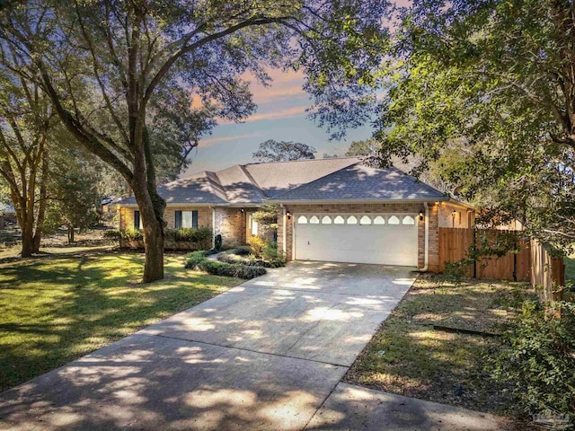 view of front facade featuring a garage and a yard