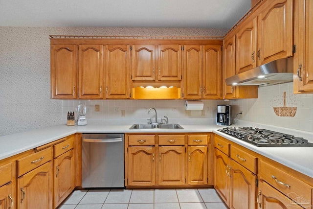 kitchen featuring light tile patterned floors, backsplash, appliances with stainless steel finishes, and sink