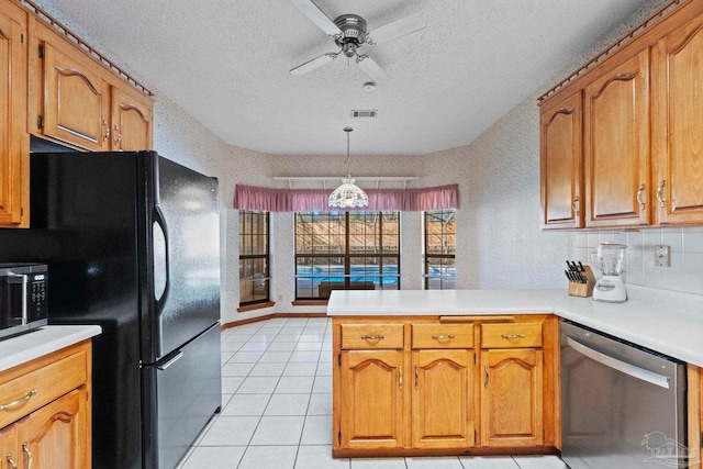 kitchen with a textured ceiling, hanging light fixtures, black fridge, kitchen peninsula, and stainless steel dishwasher