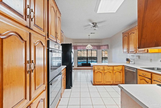 kitchen with decorative light fixtures, decorative backsplash, kitchen peninsula, ceiling fan, and stainless steel dishwasher