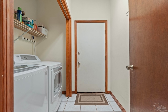 laundry room with light tile patterned floors and washing machine and clothes dryer