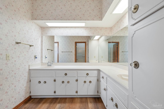 bathroom with vanity and wood-type flooring