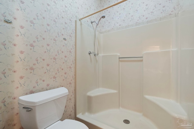 bathroom with toilet and walk in shower