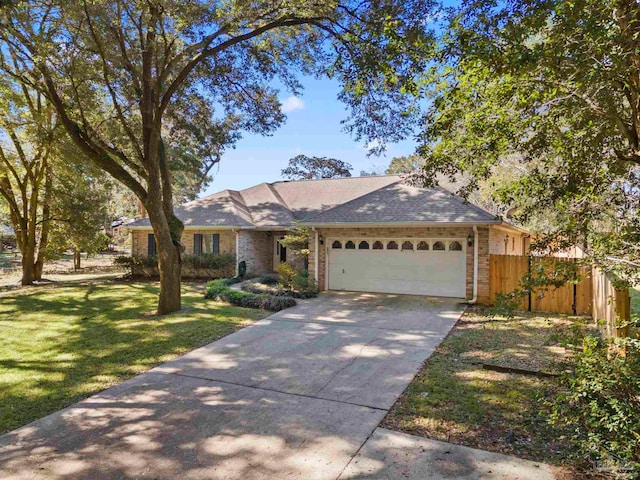 ranch-style home with a garage and a front yard