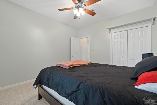 carpeted bedroom with ceiling fan and a closet