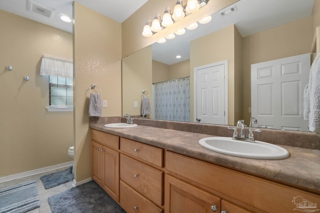 bathroom featuring toilet, vanity, and tile patterned floors