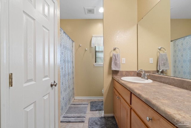 bathroom with vanity and tile patterned floors