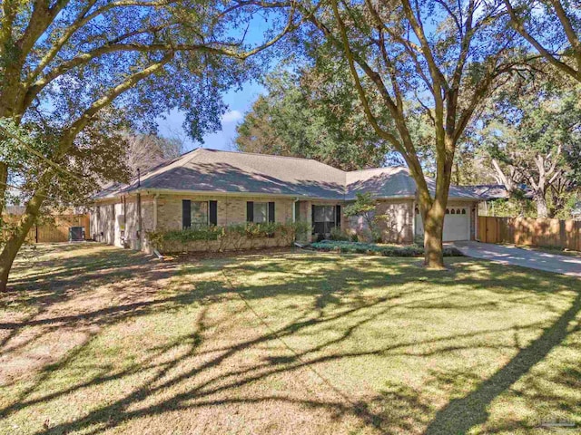 ranch-style home featuring a front lawn and a garage