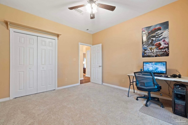 carpeted office featuring ceiling fan