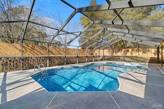 view of pool with a lanai and a patio