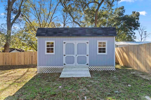 view of outbuilding featuring a lawn