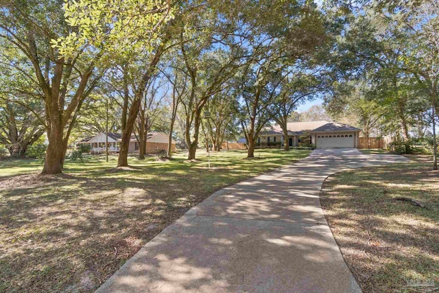 ranch-style house featuring a front lawn and a garage