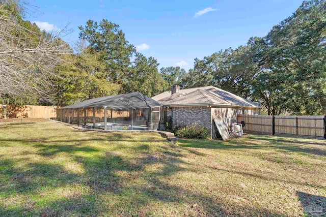 back of house featuring a swimming pool and a yard