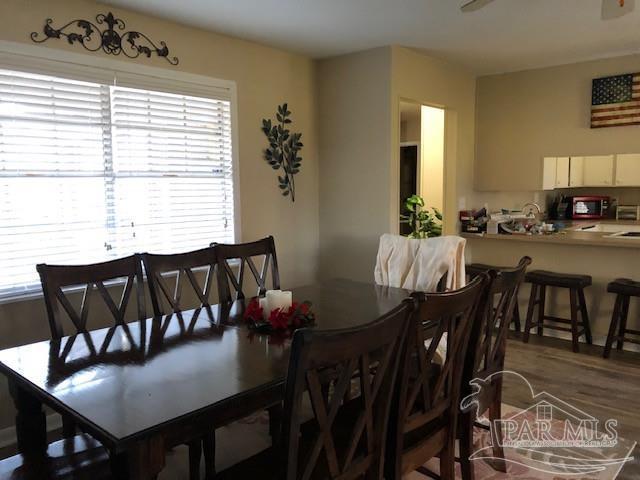 dining space featuring wood-type flooring